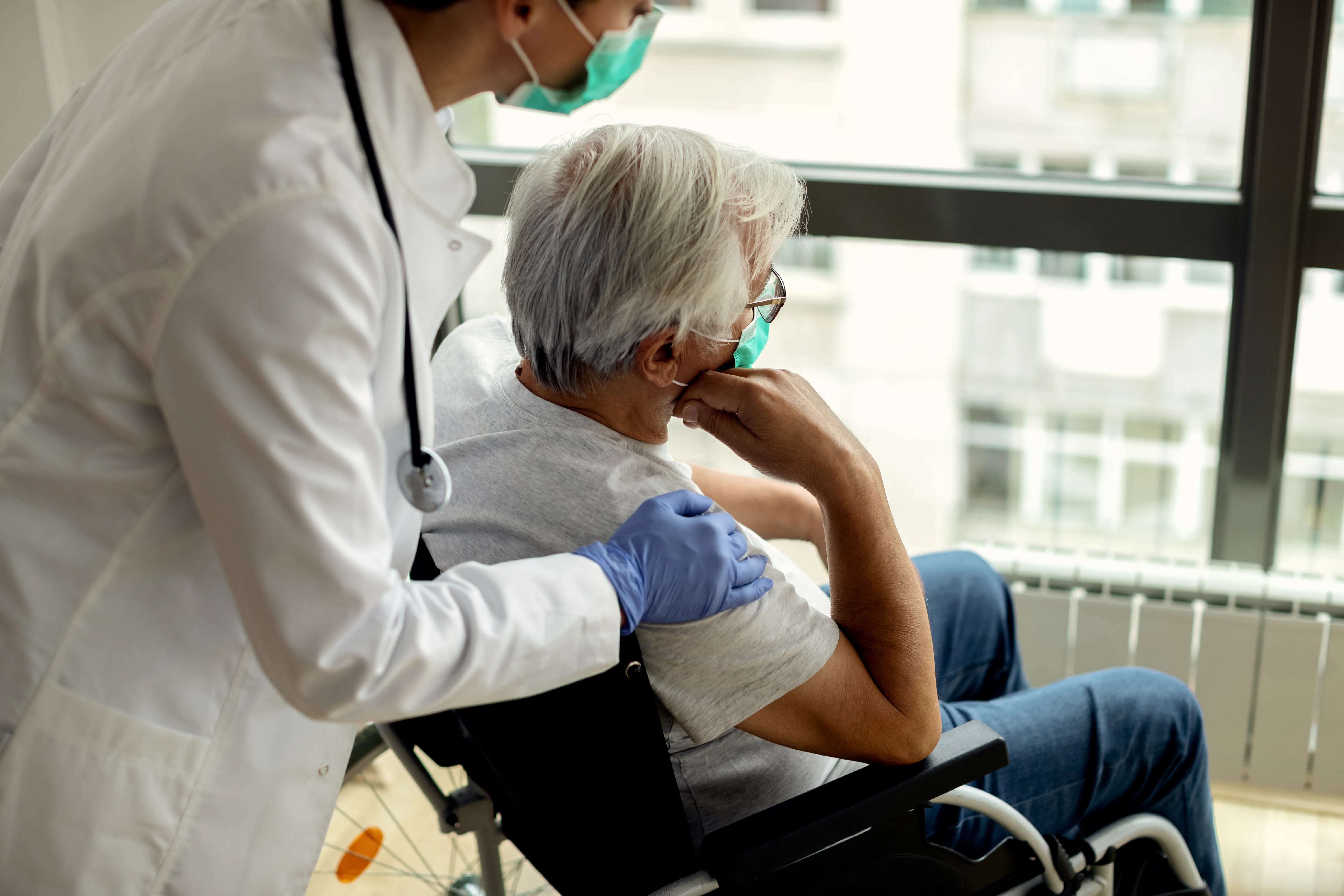 Physician reviewing chronic patient records in an Eastern Medicine OPD setting — long-term care and monitoring